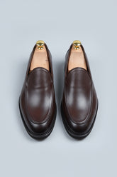 Brown slip-on leather formal shoes with a classic design and elegant finish.